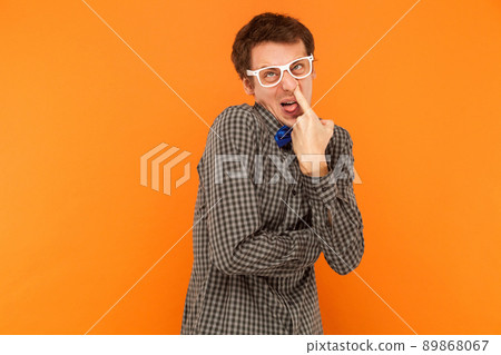 Laboratory assistant showing stupid and crazy faces. Studio shot. Isolated on orange background Laboratory assistant showing stupid and crazy faces. Studio shot. Isolated on orange background 89868067