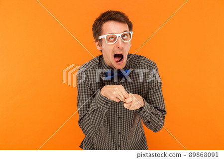 Manager wry stupid and funny faces. Studio shot. Isolated on orange background 89868091
