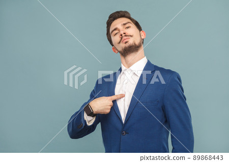 Closeup portrait of proud man pointing finger himself. Business people concept, richly and success. Indoor, studio shot on light blue background 89868443