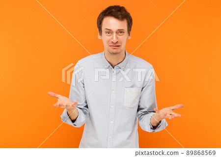 Cry and sadness, bad emotions concept. Stressed man crying. Studio shot, orange background Cry and sadness, bad emotions concept. Stressed man crying. Studio shot, orange background 89868569