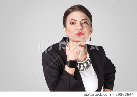 Lovely businesswoman ,sending air kiss with love to you. Studio shot, indoor. Isolated on grey background Lovely businesswoman ,sending air kiss with love to you. Studio shot, indoor. Isolated on grey background 89868644
