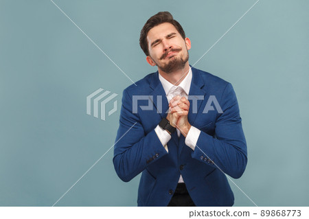 Please forgive me! Guy made a big mistake. Business people concept, richly and success. Indoor, studio shot on light blue background Please forgive me! Guy made a big mistake. Business people concept, richly and success. Indoor, studio shot on light blue background 89868773