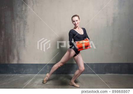 Happiness blonde laisure active dancer showing gift box. Studio shot 89868807