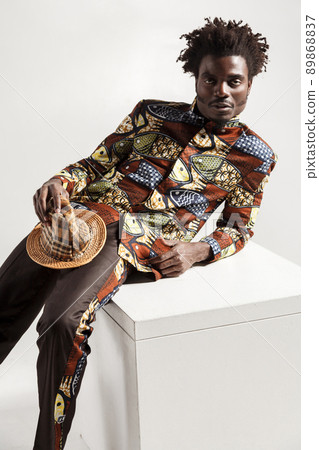 Closeup photo of fashion africam model in traditional clothes. Indoor, isolated on gray background Closeup photo of fashion africam model in traditional clothes. Indoor, isolated on gray background 89868837