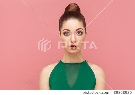 Closeup portrait of surprised beautiful woman with perfect makeup. Expression emotion and feelings concept. Studio shot, isolated on pink background Closeup portrait of surprised beautiful woman with perfect makeup. Expression emotion and feelings concept. Studio shot, isolated on pink background 89868920
