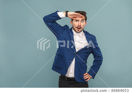 Businessman with surprised face looking away. Business people concept, richly and success. Indoor, studio shot on light blue background 89869053
