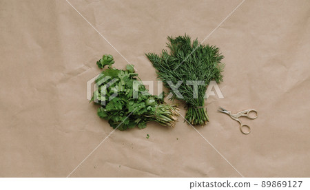 Bunches of fresh greens and organic herbs on beige background. Healthy food. Flat lay, top view, copy space 89869127