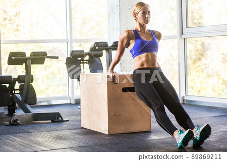 Woman doing push up on triceps and biceps. Studio shot 89869211