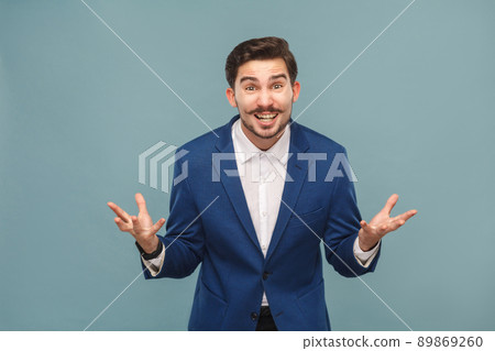 How you did this? Portrait of stressed manager in work. Business people concept, richly and success. Indoor, studio shot on light blue background How you did this? Portrait of stressed manager in work. Business people concept, richly and success. Indoor, studio shot on light blue background 89869260