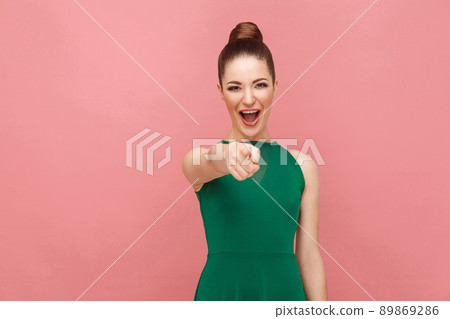 Ha-ha! Woman pointing finger at camera and toothy smiling. Expression emotion and feelings concept. Studio shot, isolated on pink background Ha-ha! Woman pointing finger at camera and toothy smiling. Expression emotion and feelings concept. Studio shot, isolated on pink background 89869286