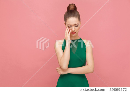 Portrait of unhappy sadness woman with collected hair cry. Expression emotion and feelings concept. Studio shot, isolated on pink background Portrait of unhappy sadness woman with collected hair cry. Expression emotion and feelings concept. Studio shot, isolated on pink background 89869372