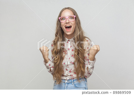 Win! Beautiful long haired blonde woman shout and have a happiness look. Studio shot Win! Beautiful long haired blonde woman shout and have a happiness look. Studio shot 89869509