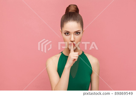 Woman showing shh, silence sign. Expression emotion and feelings concept. Studio shot, isolated on pink background Woman showing shh, silence sign. Expression emotion and feelings concept. Studio shot, isolated on pink background 89869549
