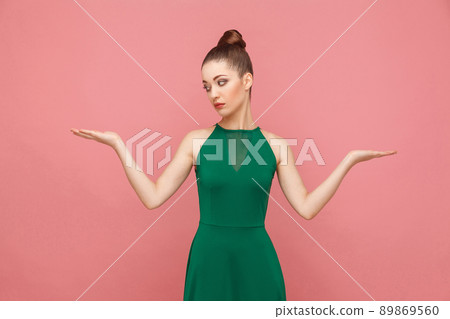 Hard choice. I don't know. Portrait of attractive beautiful puzzled woman. Expression emotion and feelings concept. Studio shot, isolated on pink background 89869560