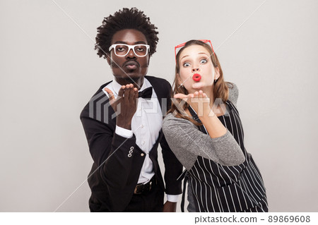 Love concept. Couple send air kisses at camera. Studio shot Love concept. Couple send air kisses at camera. Studio shot 89869608