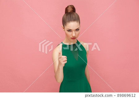 Angry teacher alert you, showing finger, looking serious at camera. Expression emotion and feelings concept. Studio shot, isolated on pink background Angry teacher alert you, showing finger, looking serious at camera. Expression emotion and feelings concept. Studio shot, isolated on pink background 89869612
