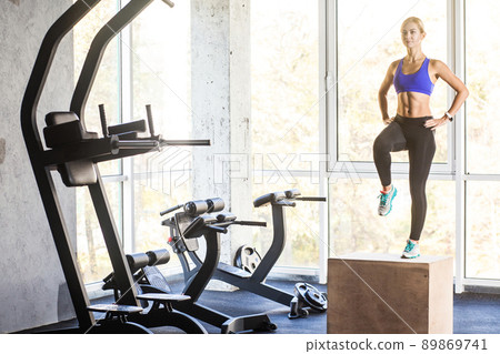 Cross fit concept. Woman in gym step up on box. Studio shot 89869741