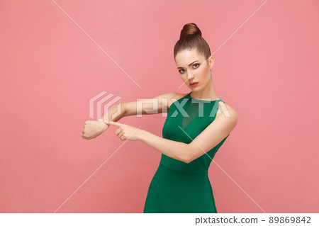 Look in my watch, time is gone! Hurry up. Expression emotion and feelings concept. Studio shot, isolated on pink background Look in my watch, time is gone! Hurry up. Expression emotion and feelings concept. Studio shot, isolated on pink background 89869842