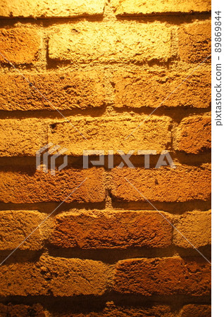 Brick wall with shadows on the unevenness Brick wall with shadows on the unevenness 89869844