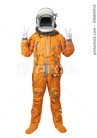 Astronaut wearing orange spacesuit and helmet showing hands with victory sign gestures isolated on white background. 89869958