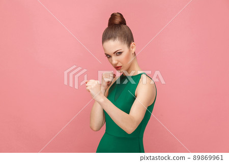 Aggressive woman boxing. Expression emotion and feelings concept. Studio shot, isolated on pink background 89869961