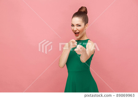 Cute woman choice fingers at camera. Expression emotion and feelings concept. Studio shot, isolated on pink background Cute woman choice fingers at camera. Expression emotion and feelings concept. Studio shot, isolated on pink background 89869963