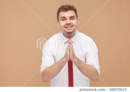 Business man say please forgive me i need money. Business people concept, good and bad emotion and feelings. Studio shot, isolated on light brown background Business man say please forgive me i need money. Business people concept, good and bad emotion and feelings. Studio shot, isolated on light brown background 89870015