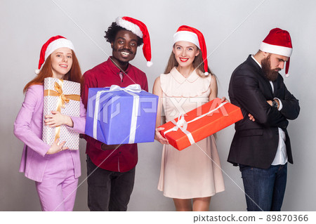 Puffed up and hurt concept. Man did not receive a gift for christmas. Studio shot, gray background Puffed up and hurt concept. Man did not receive a gift for christmas. Studio shot, gray background 89870366