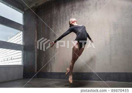 Beautiful ballerina jumping, soaring in the air and fly. Studio shot Beautiful ballerina jumping, soaring in the air and fly. Studio shot 89870435
