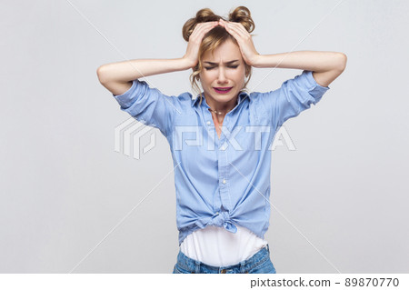 Bad emotions and feelings concept. Headache. Blonde woman touching head and have a migraine. Studio shot 89870770