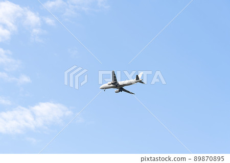 plane flying in blue sky, preparing for landing. plane flying in blue sky, preparing for landing. 89870895