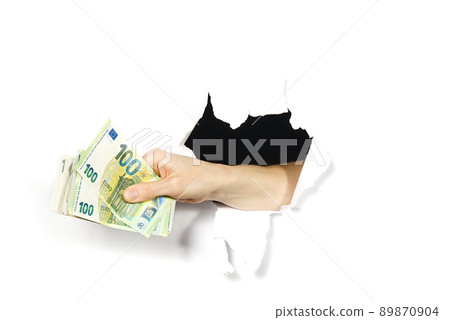 euro currency in the hands. close-up hand holding euro through hole in white paper. 89870904