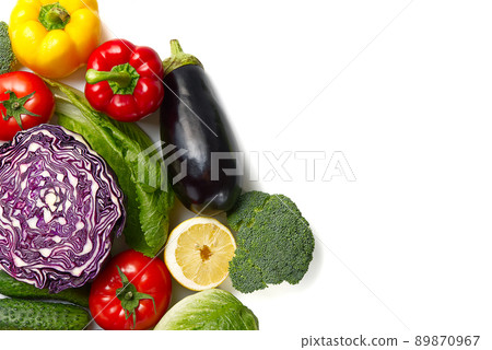 Food background border frame of colorful fresh produce raw vegetables, cucumber purple cabbage spinach tomatoes paprika onion broccoli herb, plenty of copy-space. Domestic kitchen. Vegetarian food. Food background border frame of colorful fresh produce raw vegetables, cucumber purple cabbage spinach tomatoes paprika onion broccoli herb, plenty of copy-space. Domestic kitchen. Vegetarian food. 89870967