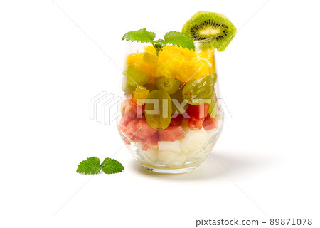 Fruit salad in the glass on white background. glass of fresh fruit salad with mint leaves on white background Fruit salad in the glass on white background. glass of fresh fruit salad with mint leaves on white background 89871078