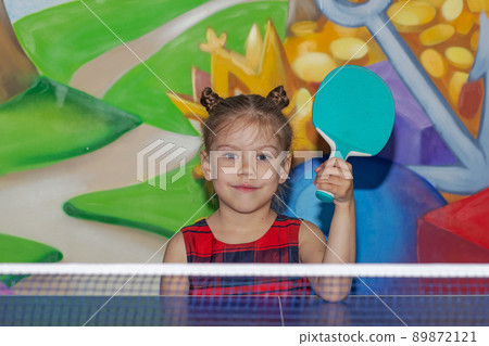 Happy child holding ping pong racket Happy child holding ping pong racket 89872121