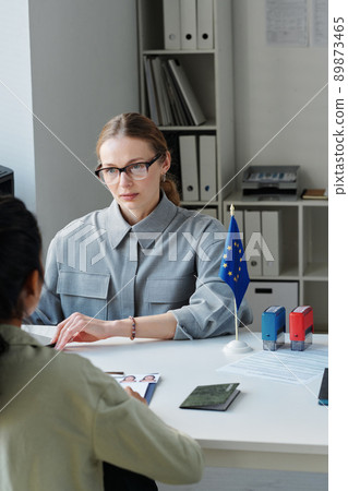 Vertical shot of unrecognizable woman applying for travel visa having appointment in embassy 89873465