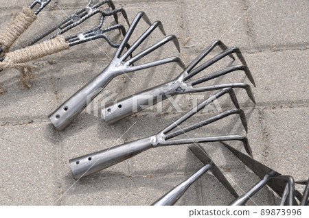 Small iron rake, gardening tool. Set of gardening hoes Small iron rake, gardening tool. Set of gardening hoes 89873996