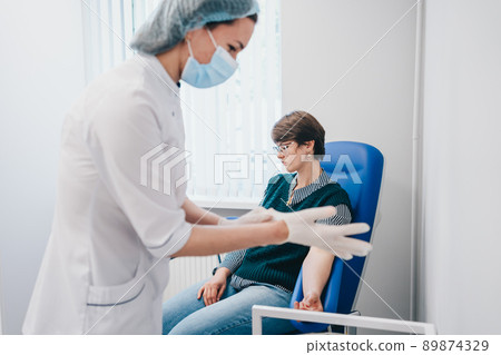 Preparation for blood tests. The woman came to the clinic. 89874329