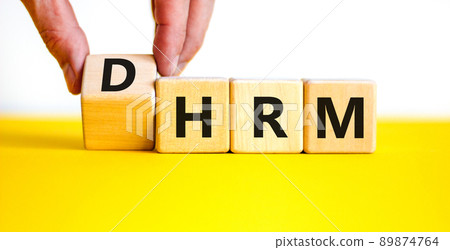 DHRM, domestic human resource management HRM symbol. Words DHRM, domestic human resource management on cubes on a beautiful white background. Businessman hand. Business, DHRM HRM concept. Copy space. DHRM, domestic human resource management HRM symbol. Words DHRM, domestic human resource management on cubes on a beautiful white background. Businessman hand. Business, DHRM HRM concept. Copy space. 89874764