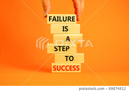Failure or success symbol. Wooden blocks with words A failure is a step to success. Beautiful orange table orange background. Businessman hand. Business, failure or success concept. Copy space. 89874812