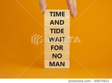 Time to action symbol. Wooden blocks with words time and tide wait for no man. Beautiful orange background. Businessman hand. Business and time to action concept. Copy space. Time to action symbol. Wooden blocks with words time and tide wait for no man. Beautiful orange background. Businessman hand. Business and time to action concept. Copy space. 89874822