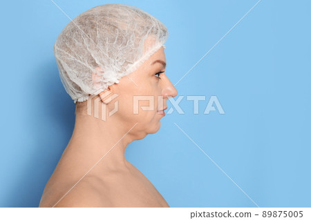 Mature woman with double chin on blue background. Space for text Mature woman with double chin on blue background. Space for text 89875005