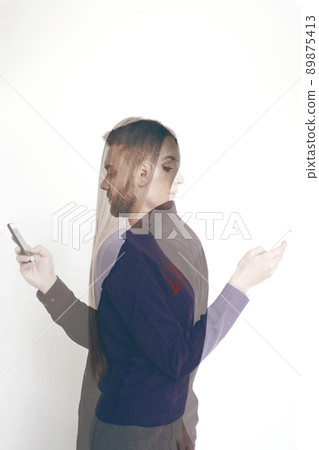 Double exposure portrait of young bearded man and attractive long-haired woman using smartphones on white background 89875413
