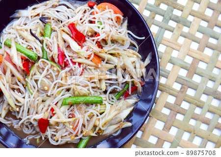 Spicy green papaya salad with vermicelli on white Spicy green papaya salad with vermicelli on white 89875708