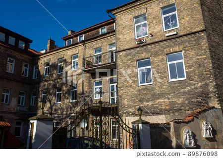 An old three-story building on one of the streets in the Uzupis district in Vilnius. An old three-story building on one of the streets in the Uzupis district in Vilnius. 89876098