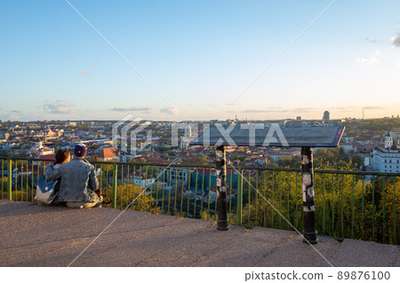 Lovers enjoy the view of the old city on the Three Crosses Hill in Vilnius. Lovers enjoy the view of the old city on the Three Crosses Hill in Vilnius. 89876100