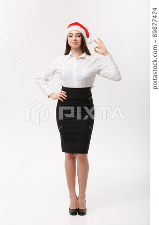 Business Concept - Modern caucasian business woman in the white studio background giving ok sign. Business Concept - Modern caucasian business woman in the white studio background giving ok sign. 89877474