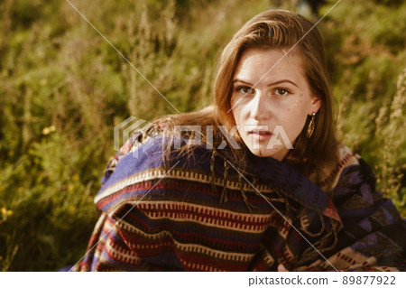 on the grass sits in an ethno cape girl with red hair natural beauty on the grass sits in an ethno cape girl with red hair natural beauty 89877922