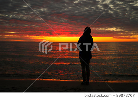 A Young Adolescent Girl Looks up in Awe, Wonder, and Admiration at a Magnificent Sunset Sky A Young Adolescent Girl Looks up in Awe, Wonder, and Admiration at a Magnificent Sunset Sky 89878707