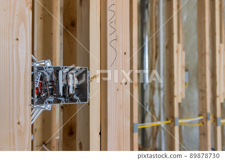 Electrician routing wires in electric plug connector electric sockets on the wall 89878730